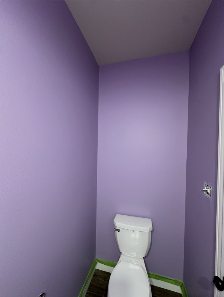 A small bathroom freshly painted lavender